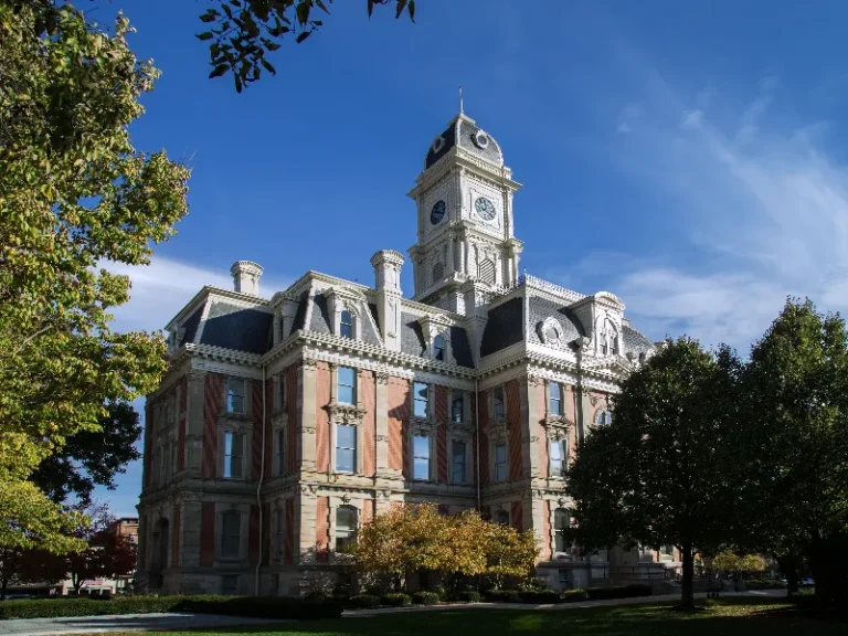 Historic courthouse building with a clock tower under a clear blue sky.