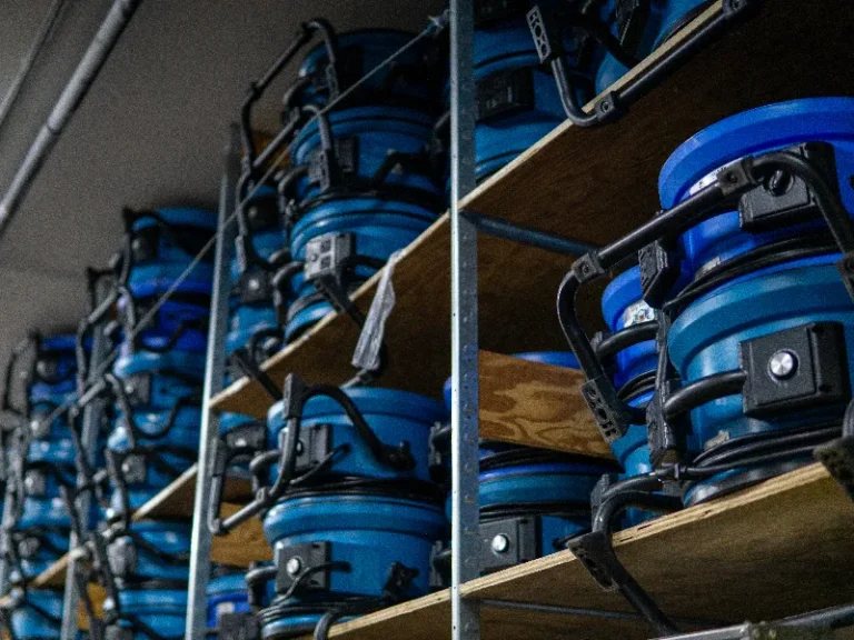Shelves filled with stacked blue industrial air movers or fans.